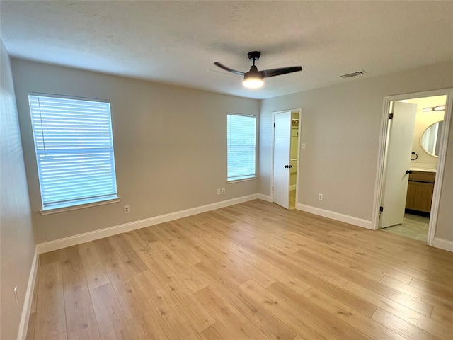 1935 Creekshire Dr, Sugar Land, TX 77478 - unfurnished bedroom featuring multiple windows, light wood-style flooring, and baseboards