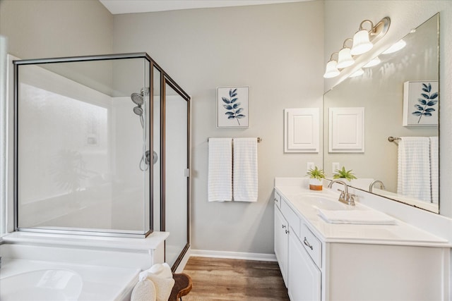 12427 Adams Ridge Ln, Humble, TX 77346 - bathroom with a stall shower, vanity, wood finished floors, and baseboards