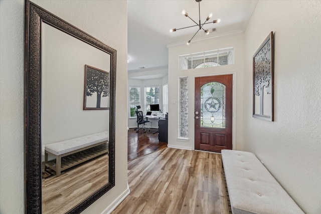 12427 Adams Ridge Ln, Humble, TX 77346 - entryway with a chandelier, crown molding, light wood-style floors, baseboards, and a textured wall