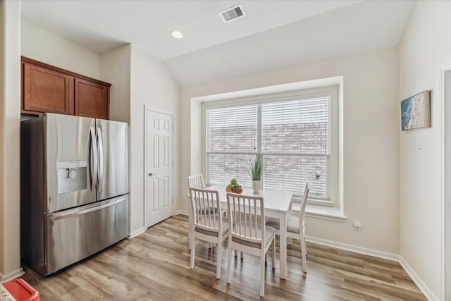 12427 Adams Ridge Ln, Humble, TX 77346 - dining room featuring light wood-type flooring, baseboards, and vaulted ceiling