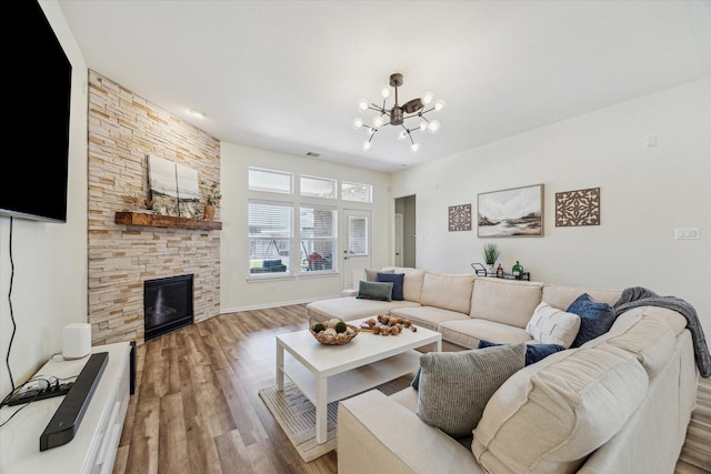 12427 Adams Ridge Ln, Humble, TX 77346 - living area featuring a chandelier, wood finished floors, and a fireplace