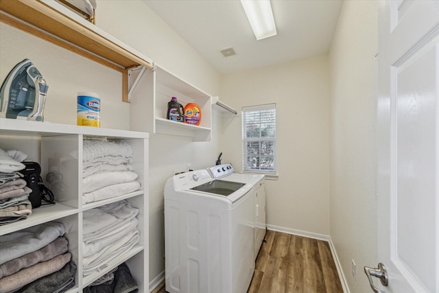 12427 Adams Ridge Ln, Humble, TX 77346 - laundry room with independent washer and dryer, wood finished floors, and baseboards