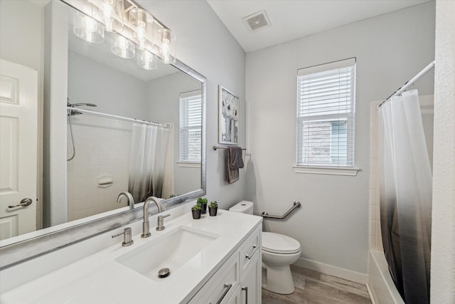 12427 Adams Ridge Ln, Humble, TX 77346 - bathroom featuring wood finished floors, vanity, toilet, shower / bath combination with curtain, and baseboards