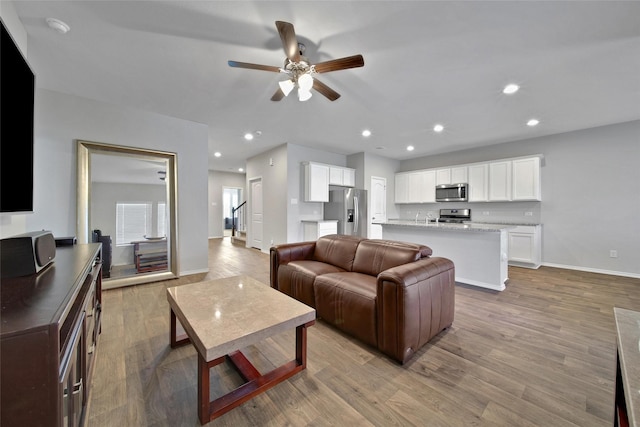 13854 Rock Island Trl, Conroe, TX 77384 - living area featuring a ceiling fan, baseboards, light wood-style floors, and recessed lighting