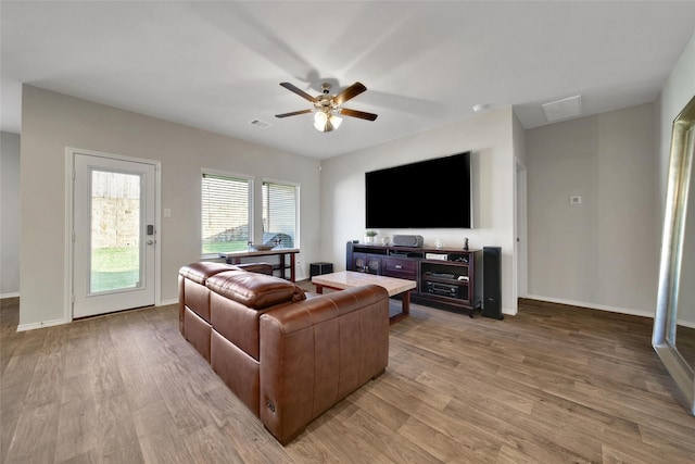 13854 Rock Island Trl, Conroe, TX 77384 - living area featuring light wood finished floors, ceiling fan, and baseboards