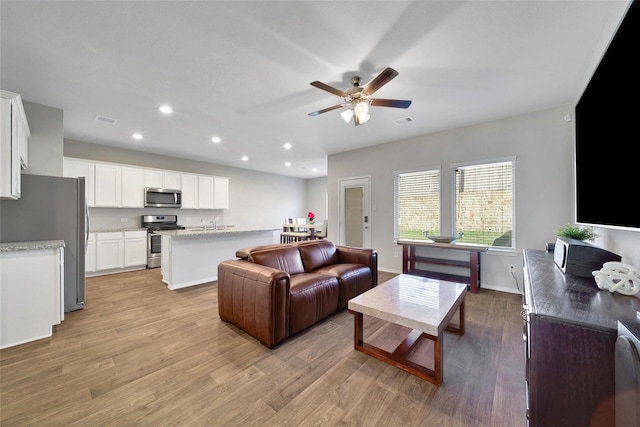 13854 Rock Island Trl, Conroe, TX 77384 - living area with recessed lighting, light wood finished floors, a ceiling fan, and baseboards
