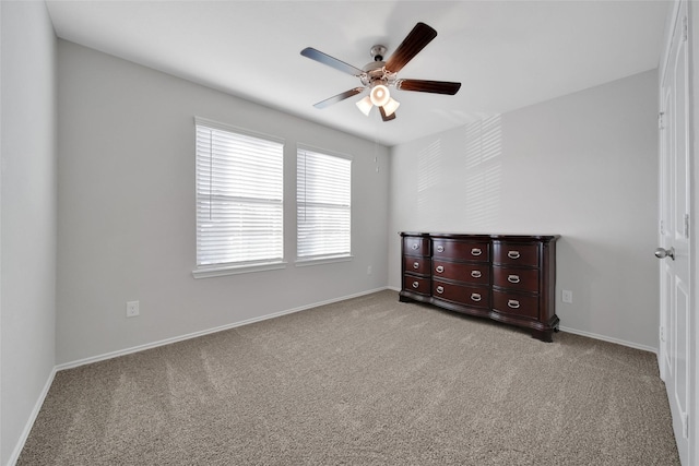 13854 Rock Island Trl, Conroe, TX 77384 - unfurnished bedroom with carpet floors, baseboards, and ceiling fan