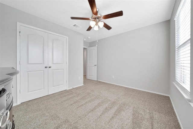 13854 Rock Island Trl, Conroe, TX 77384 - unfurnished bedroom featuring carpet flooring, multiple windows, a closet, and baseboards