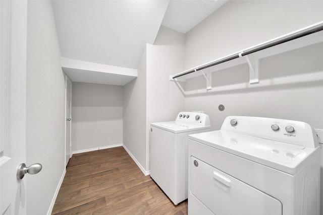 13854 Rock Island Trl, Conroe, TX 77384 - laundry area featuring washer and clothes dryer, light wood-style floors, and baseboards