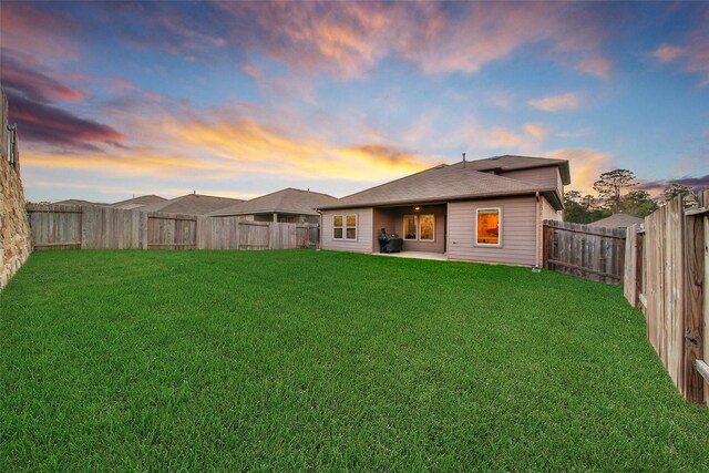 13854 Rock Island Trl, Conroe, TX 77384 - back of property at dusk featuring a patio area
