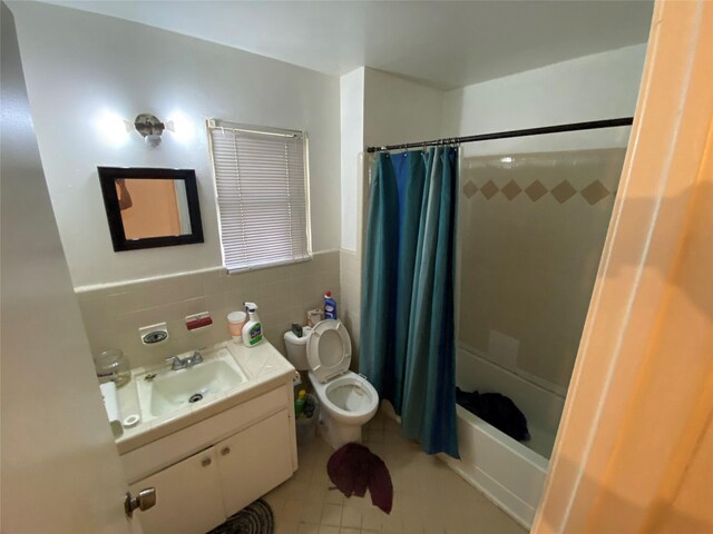 4403 Trailwood Dr, San Antonio, TX 78228 - bathroom featuring toilet, vanity, tile patterned floors, shower / bath combination with curtain, and tile walls