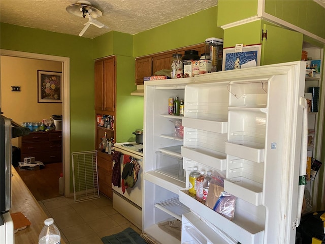 4403 Trailwood Dr, San Antonio, TX 78228 - kitchen featuring open shelves, tile patterned flooring, ceiling fan, a textured ceiling, and brown cabinets