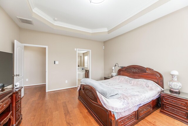 13422 Great Creek Dr, Pearland, TX 77584 - bedroom featuring ornamental molding, light wood finished floors, a raised ceiling, baseboards, and ensuite bathroom