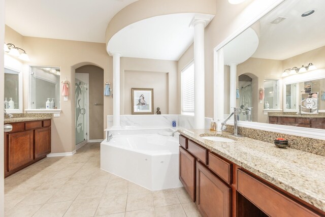 13422 Great Creek Dr, Pearland, TX 77584 - full bath featuring a stall shower, decorative columns, a garden tub, tile patterned flooring, and two vanities