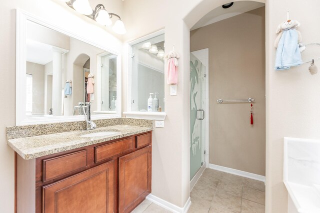 13422 Great Creek Dr, Pearland, TX 77584 - bathroom featuring a stall shower, vanity, tile patterned flooring, and baseboards