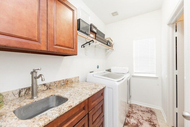13422 Great Creek Dr, Pearland, TX 77584 - washroom featuring cabinet space, washer and clothes dryer, baseboards, and light tile patterned flooring