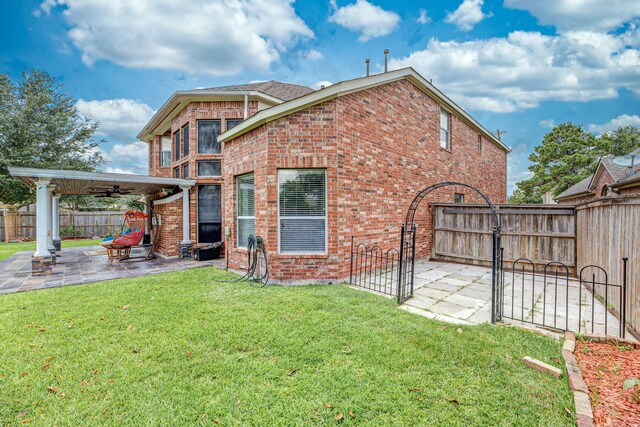 13422 Great Creek Dr, Pearland, TX 77584 - back of property with a gate, brick siding, and a patio area