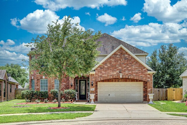 13422 Great Creek Dr, Pearland, TX 77584 - view of front facade with driveway, an attached garage, and brick siding