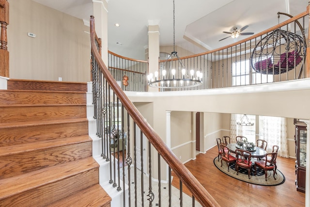 13422 Great Creek Dr, Pearland, TX 77584 - stairs with a chandelier, healthy amount of natural light, wood finished floors, ceiling fan, and a towering ceiling