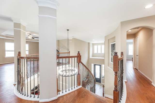 13422 Great Creek Dr, Pearland, TX 77584 - corridor with an upstairs landing, arched walkways, wood finished floors, decorative columns, and baseboards