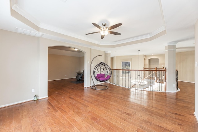13422 Great Creek Dr, Pearland, TX 77584 - empty room with a tray ceiling, a ceiling fan, ornamental molding, wood-type flooring, and baseboards