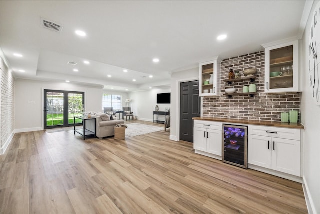 2007 Ottawa Ln, Houston, TX 77043 - living room featuring wine cooler, light wood-style floors, baseboards, and recessed lighting