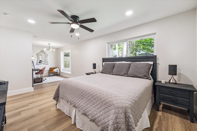 2007 Ottawa Ln, Houston, TX 77043 - bedroom with light wood-type flooring, recessed lighting, baseboards, a chandelier, and ceiling fan