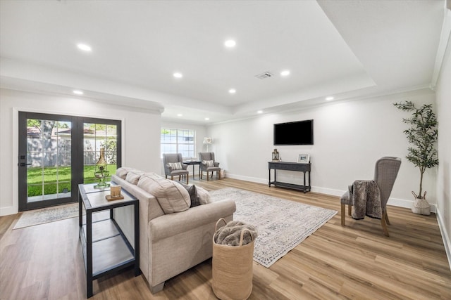 2007 Ottawa Ln, Houston, TX 77043 - living room featuring a tray ceiling, recessed lighting, light wood-type flooring, and baseboards
