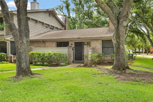 2711 Grants Lake Blvd Unit 144, Sugar Land, TX 77479 - view of front facade with a chimney and a front yard