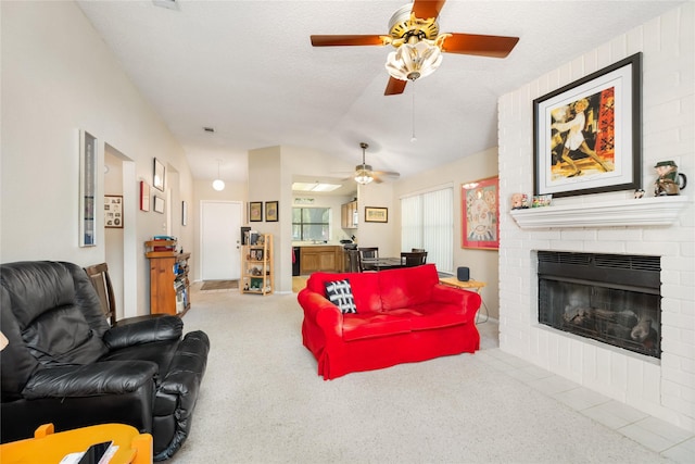 2711 Grants Lake Blvd Unit 144, Sugar Land, TX 77479 - carpeted living area featuring a ceiling fan, lofted ceiling, a fireplace, and a textured ceiling