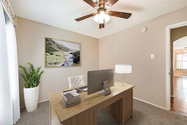 19426 Dolan Springs Dr, Tomball, TX 77377 - office with dark carpet, a ceiling fan, baseboards, and arched walkways