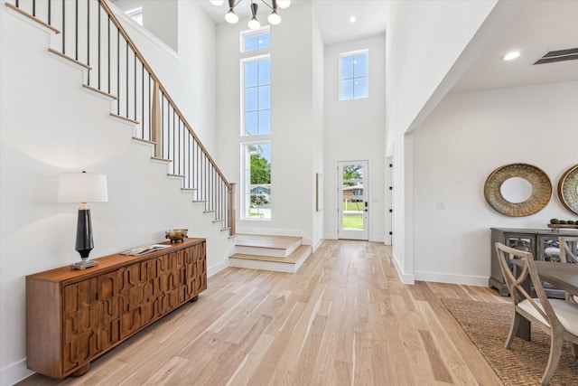 1707 Nina Lee Ln, Houston, TX 77018 - entryway with stairs, a high ceiling, light wood-style floors, healthy amount of natural light, and baseboards