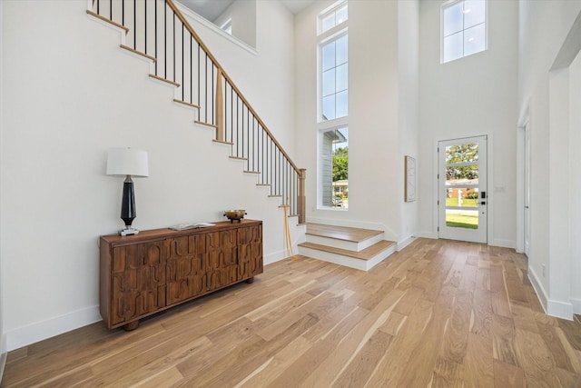 1707 Nina Lee Ln, Houston, TX 77018 - entryway featuring light wood-type flooring, a towering ceiling, stairway, healthy amount of natural light, and baseboards