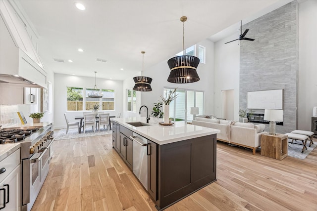 1707 Nina Lee Ln, Houston, TX 77018 - kitchen with appliances with stainless steel finishes, a sink, light wood-type flooring, light countertops, and recessed lighting