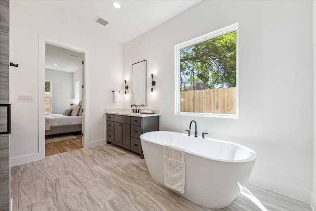 1707 Nina Lee Ln, Houston, TX 77018 - ensuite bathroom with a freestanding bath, vanity, baseboards, and recessed lighting