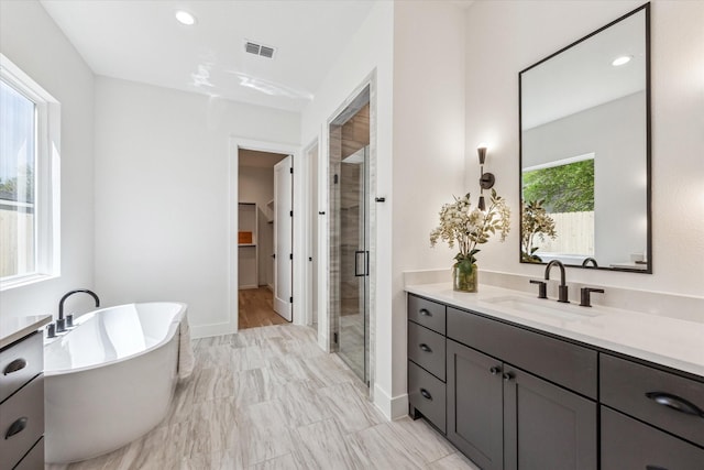 1707 Nina Lee Ln, Houston, TX 77018 - bathroom featuring vanity, a stall shower, a freestanding tub, a walk in closet, and recessed lighting
