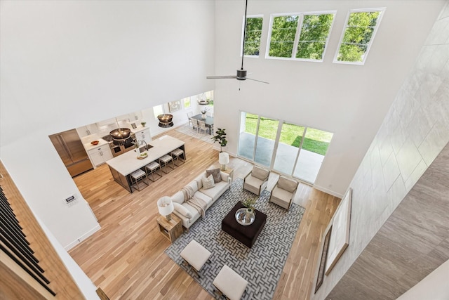 1707 Nina Lee Ln, Houston, TX 77018 - living room featuring wood finished floors, a towering ceiling, and a ceiling fan