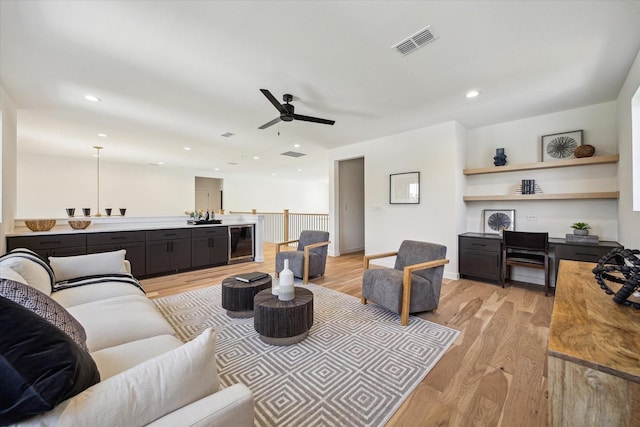1707 Nina Lee Ln, Houston, TX 77018 - living area featuring a ceiling fan, beverage cooler, light wood finished floors, and recessed lighting