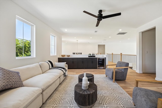 1707 Nina Lee Ln, Houston, TX 77018 - living area featuring beverage cooler, light wood finished floors, ceiling fan, baseboards, and recessed lighting