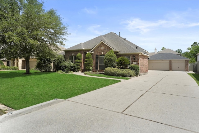 527 Oak Ridge Grove Cir, Spring, TX 77386 - view of front of house featuring brick siding, a front yard, a shingled roof, driveway, and a garage