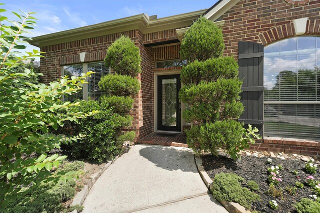 527 Oak Ridge Grove Cir, Spring, TX 77386 - view of exterior entry featuring brick siding