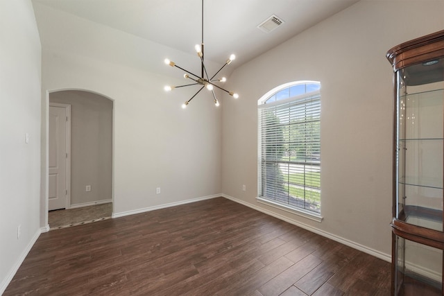 527 Oak Ridge Grove Cir, Spring, TX 77386 - unfurnished room with arched walkways, a chandelier, dark wood-type flooring, baseboards, and lofted ceiling
