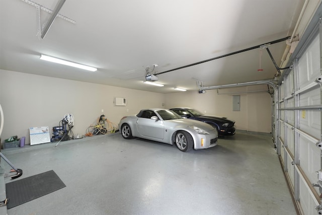 527 Oak Ridge Grove Cir, Spring, TX 77386 - garage with a garage door opener, electric panel, and a wall mounted air conditioner