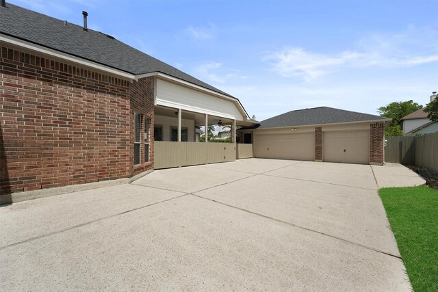 527 Oak Ridge Grove Cir, Spring, TX 77386 - view of home's exterior featuring brick siding, driveway, a garage, and roof with shingles