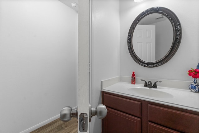 9931 Chimney Swift Ln, Conroe, TX 77385 - bathroom with wood finished floors, vanity, and baseboards