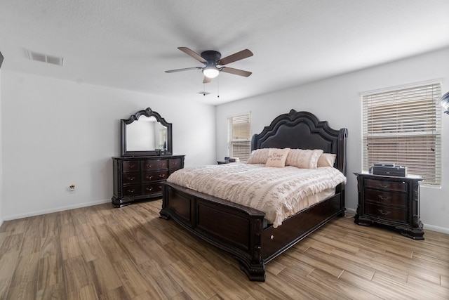 9931 Chimney Swift Ln, Conroe, TX 77385 - bedroom with light wood-type flooring, baseboards, and a ceiling fan