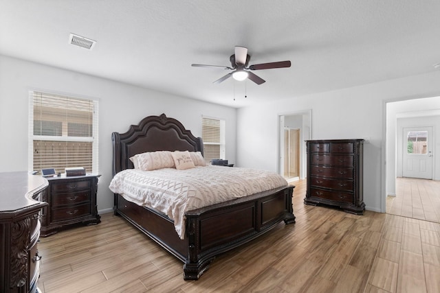 9931 Chimney Swift Ln, Conroe, TX 77385 - bedroom with light wood-style floors and ceiling fan