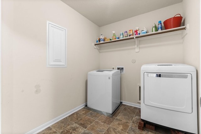 9931 Chimney Swift Ln, Conroe, TX 77385 - laundry room featuring washer and dryer, baseboards, and stone finish flooring