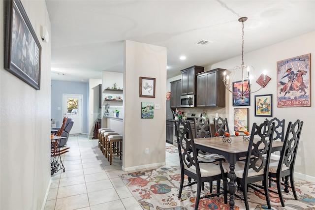 187 Deer Lake Rd, Huffman, TX 77336 - dining room with a chandelier, light tile patterned floors, and baseboards