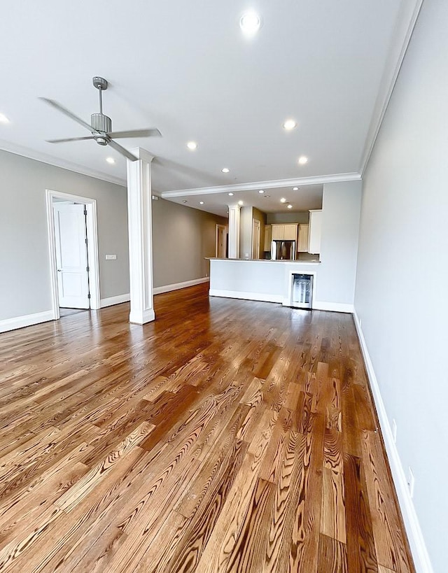 2207 Postoffice St Unit 208, Galveston, TX 77550 - unfurnished living room featuring ornamental molding, ceiling fan, recessed lighting, baseboards, and wood finished floors
